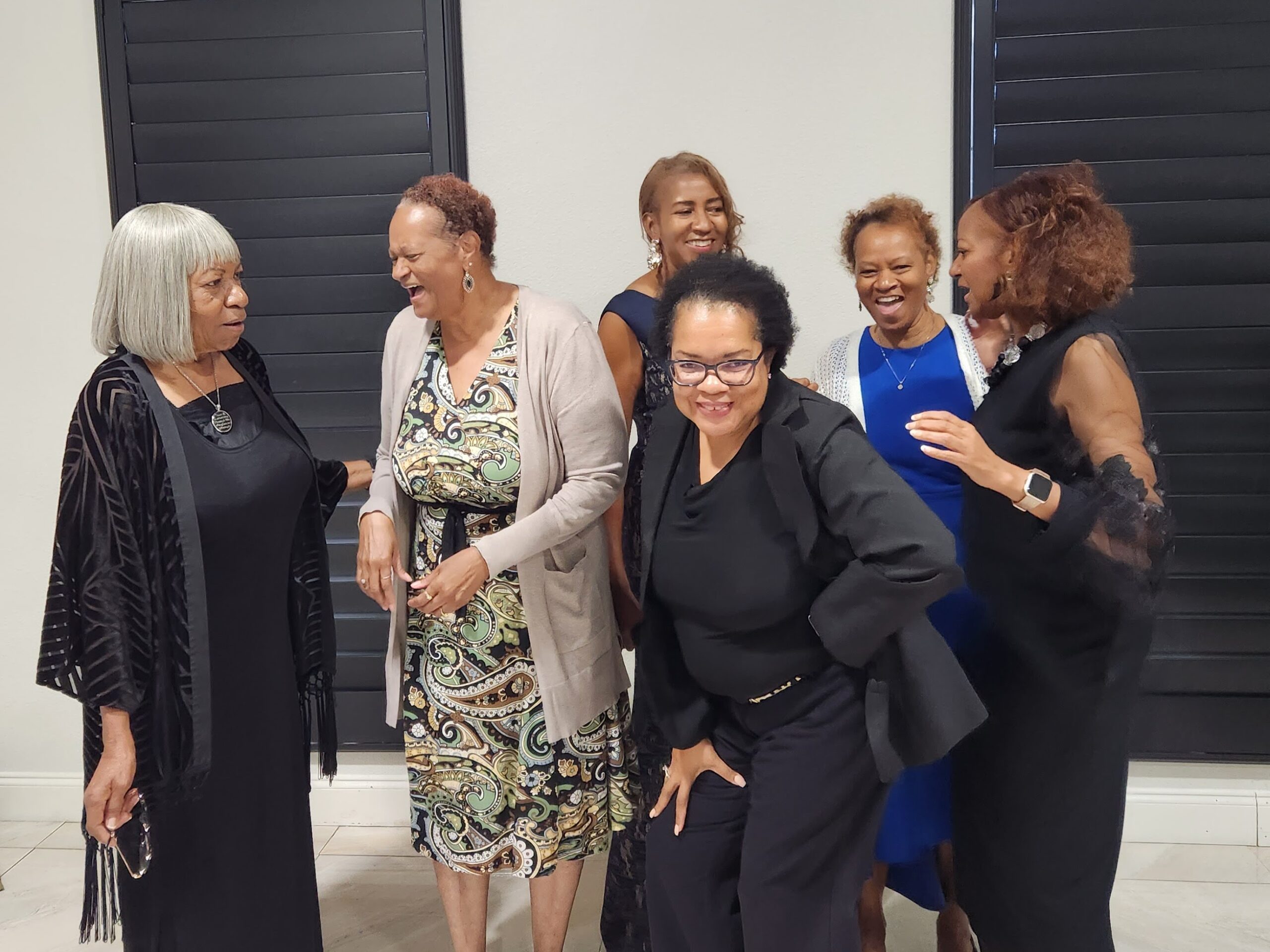 Black women gathered together, laughing and celebrating — the kind of joy our Ancestors carried forward.